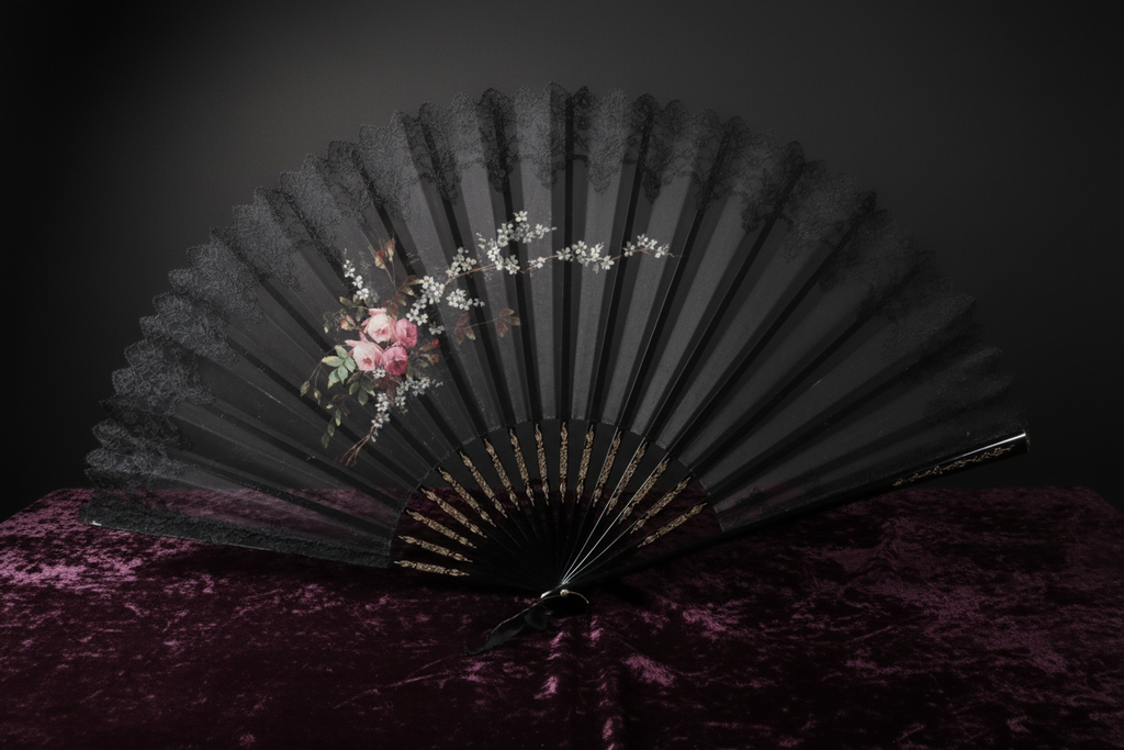 Antique Victorian black lace mourning fan displayed on dark velvet with dramatic lighting